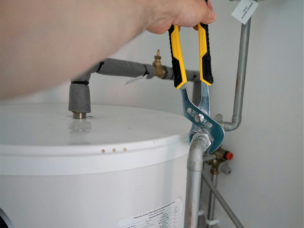Plumber working on a water heater